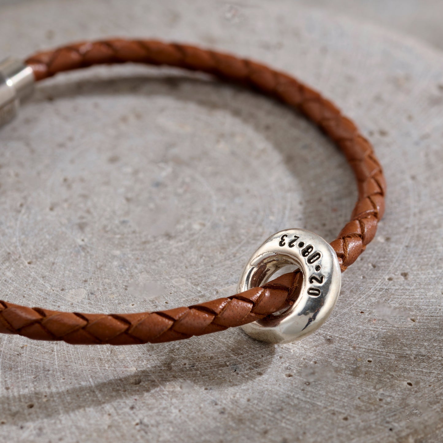 Close-up of Personalised Men’s Lucky Pebble Fine Leather Message Bracelet with brown leather and silver finish
