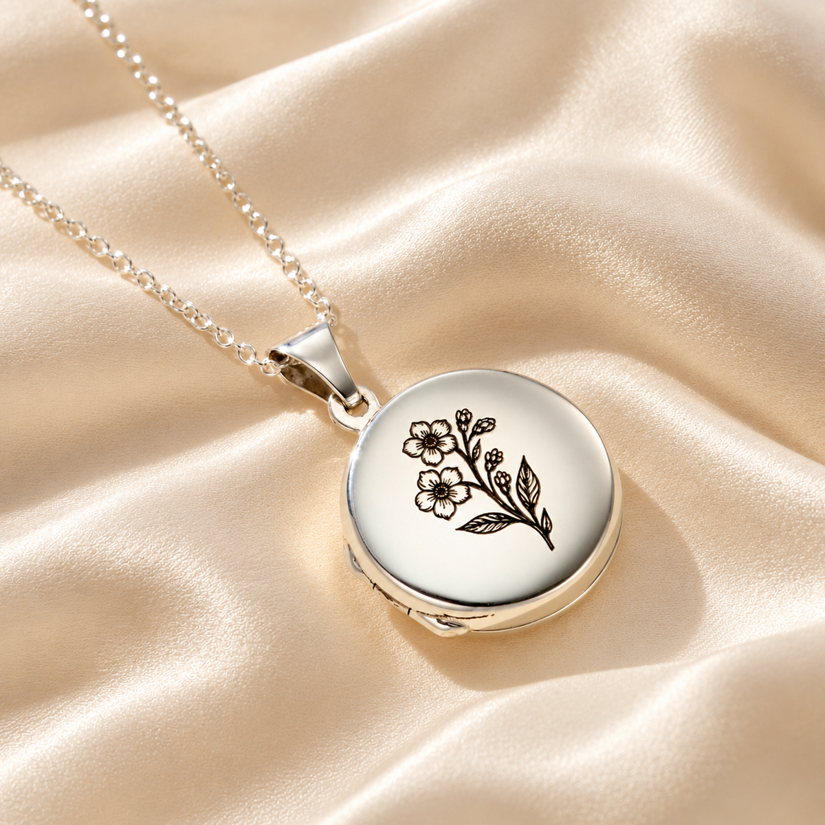 Personalised Forget Me Knot photo locket necklace in silver, featuring a floral engraved locket on ivory satin.