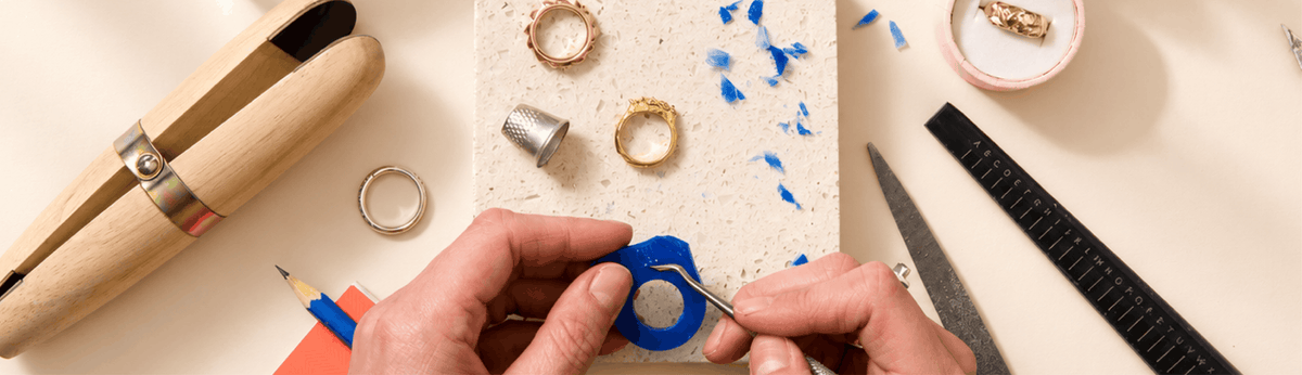 Hands carving a ring at a Posh Totty Designs jewellery workshop
