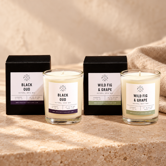 Black Oud and Wild Fig & Grape 9cl candles staged together with their individual boxes