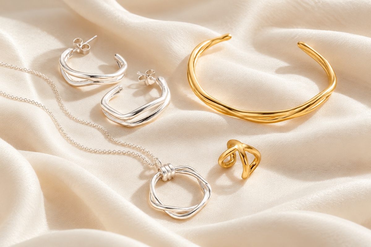Air jewellery arranged on pale stone and fabric