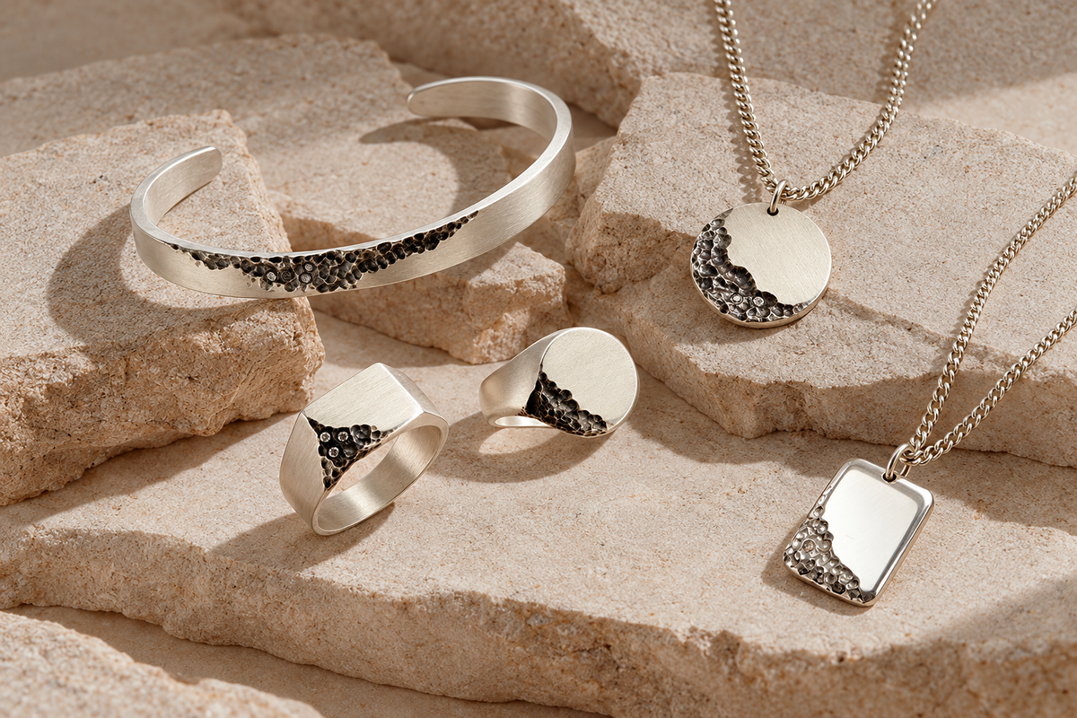 Earth jewellery arranged on pale stone and fabric
