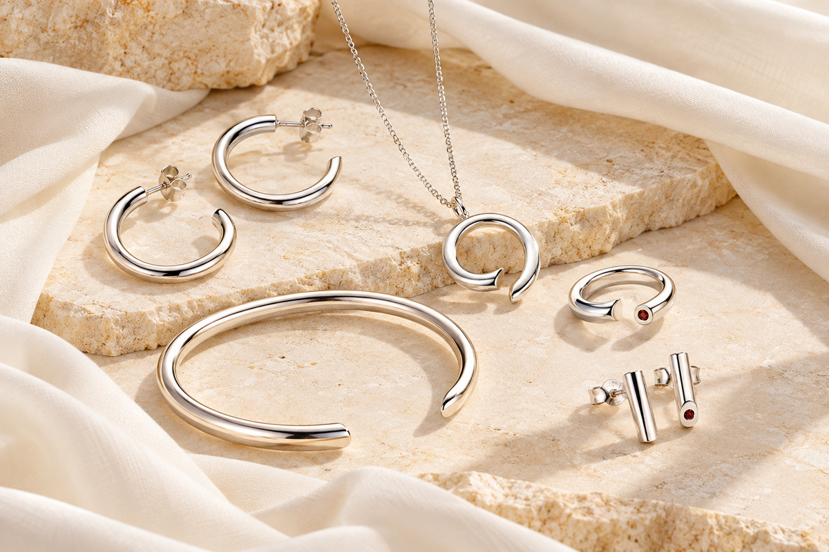 Water jewellery arranged on pale stone and fabric