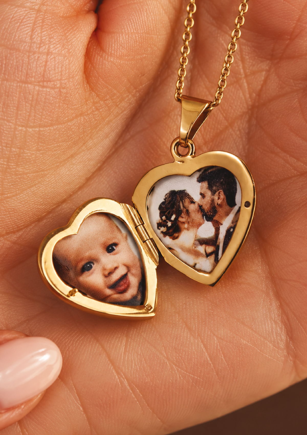 Open gold heart photo locket in a hand
