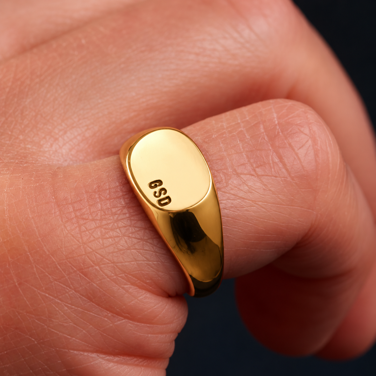 Yellow gold men's personalised signet ring worn on a hand
