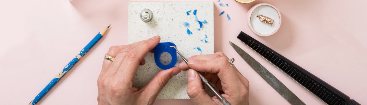 Hands carving a ring at a Posh Totty Designs jewellery workshop