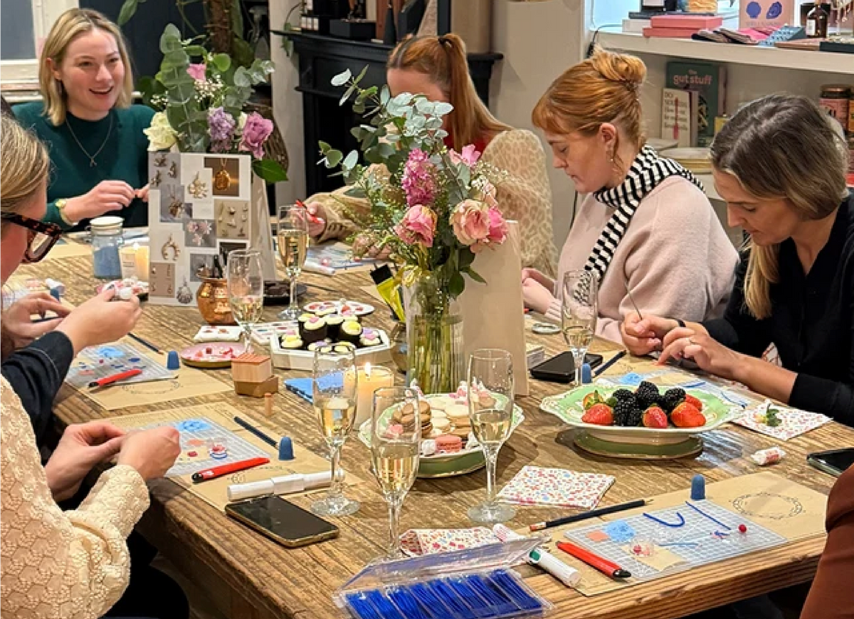 People making jewellery together at a workshop table